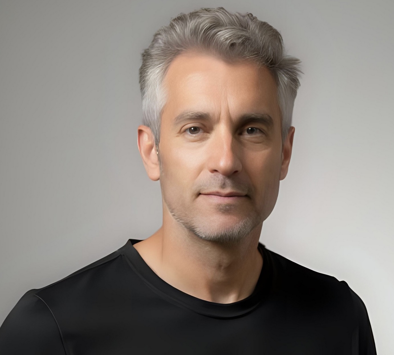 Confident silver-haired man with a short textured haircut.